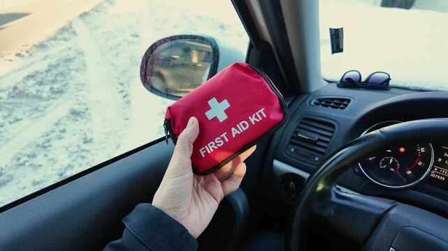 Vehicle Interior Scene Showing Attentive Driver Arranging Emergency Supplies Carefully. Scene Inside Vehicle Depicts Driver Systematically Preparing Safety Items For Emergency Situations