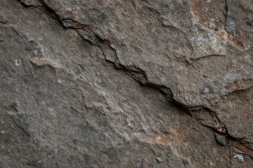 Obraz premium Detailed Close-up Texture of Rugged Natural Rock Surface with Visible Cracks and Mineral Variations Ideal for Backgrounds or Design Elements