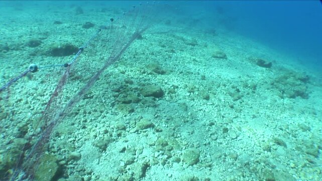 old fish net underwater ghost hunting pollution of oceans by driftnets