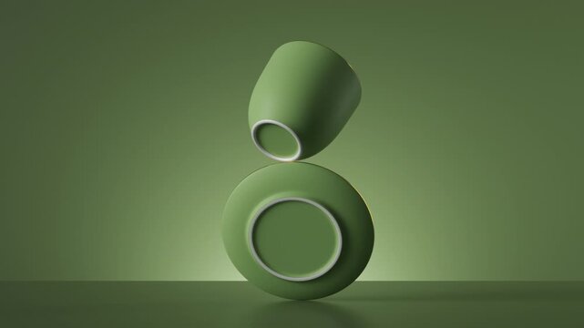 A green cup and saucer perform a balancing act on a matching background. The monochromatic green theme creates a very modern look. 3D render motion.