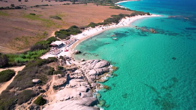 Sardinia Sant Elmo aerial flight over granite rocks and white sand beach turquoise water Italy drone 4k cinematic rugged coastline scenery Caribbean look travel
