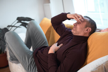 Fototapeta premium Man with gastritis, chest, stomach and abdominal pain at home.