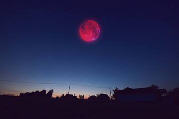 Lunar eclipse, stars and planets above landscape silhouettes. © astrosystem