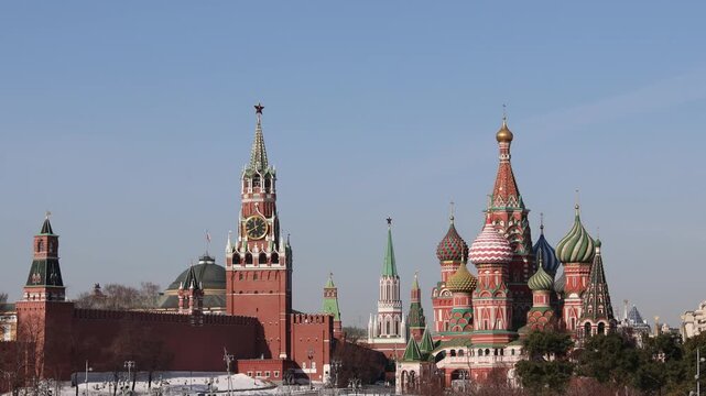 Russia. Moscow. March 12, 2026. View of Spasskaya Tower of the Kremlin and Saint Basil's Cathedral on Red Square under blue sky in sunny spring weather