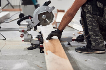 Professional handyman installing laminate flooring in a new apartment.