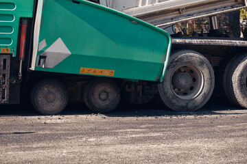 Obraz premium Heavy construction machines and truck outdoors for public street works.