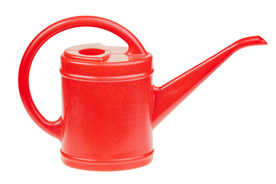 Red plastic watering can isolated on white background representing gardening, plant care and watering plants concept