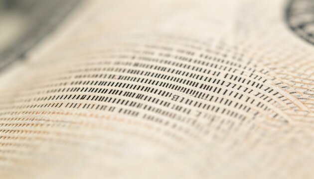 Detailed macro capture of microprinting on a banknote surface with the text and lines in sharp clarity and the surroundings softly diffused.
