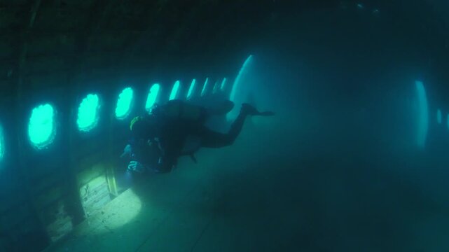c47 dakota air plane wreck underwater  fish around ocean scenery of airplane and metal on ocean floor  scenery scuba divers to explore
