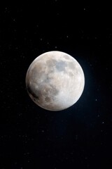 Large cratered moon glowing against deep starry night sky