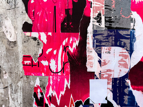 Layers of old colorful posters on wall damaged by time for your grunge style design