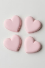 Obraz premium Four Soft Pink Heart Shapes Arranged in a Square Pattern on Light Gray Background Minimalist Flat Design Suitable for Love Valentine Wellness or Affection Themed Projects