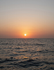 Serene Sunset over Calm Ocean with Golden Light Reflecting on Water Surface, Tranquil Natural Landscape Scene for Travel or Meditation Backgrounds