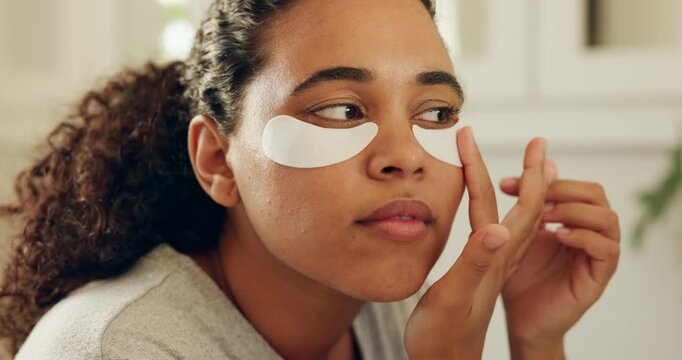 Skincare, application and woman with patches in bathroom, reduce dark circles and hydration treatment. Under eye glow, self care or person with collagen mask for grooming routine, home or dermatology