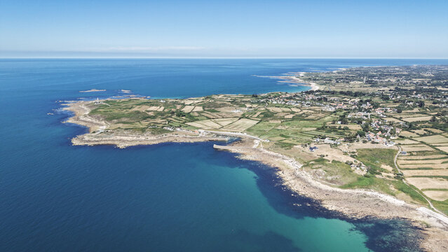Aerial view of land meets the sea, rocky coasts contrasting with the azure water, forming a picturesque landscape, Manche, Normandy, France.
