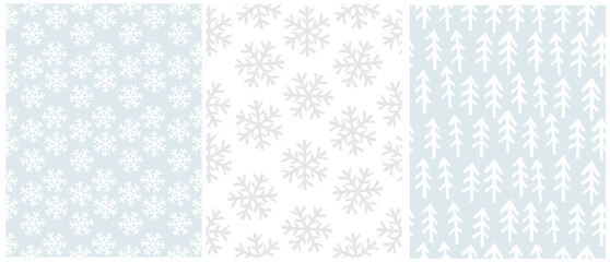 Simple Hand‑Drawn Seamless Vector Patterns - Winter Snowflakes and Pine Tree Repeats. Christmas Pattern With White and Light Gray Snowflakes On a Pastel Blue And White Background. White Trees On Blue.