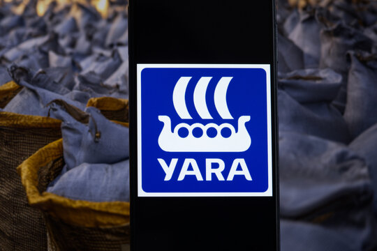 Yara International logo displayed against a background of fertilizer bags. Yara International is a Norwegian producer and distributor of crop nutrients and fertilizers.