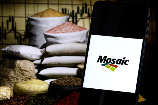 Mosaic company logo displayed against a background of fertilizer bags. The Mosaic Company is an American producer and marketer of crop nutrients and fertilizers.