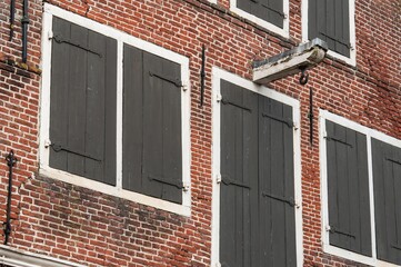 Obraz premium Traditional dutch brick facade with closed shutters