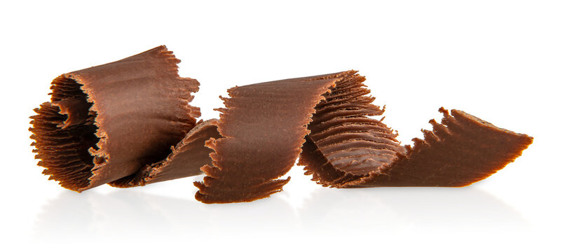 Decorative dark chocolate curls with layered texture and delicate edges, gourmet dessert topping isolated 