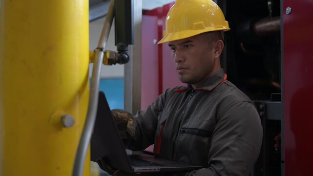 Asian industrial plant maintenance engineer inspecting factory pipeline system using digital tablet and communication radio. Professional worker checking manufacturing facility valve pressure equipmen