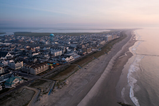 Aerial view of the beachside city, where the soft hues of dawn meet the sandy shore and the tranquil ocean, Sea Isle City, New Jersey, United States.