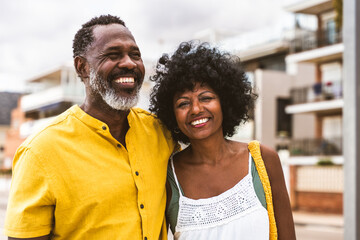Beautiful mature black couple of lovers dating at the seaside - African senior man and woman...
