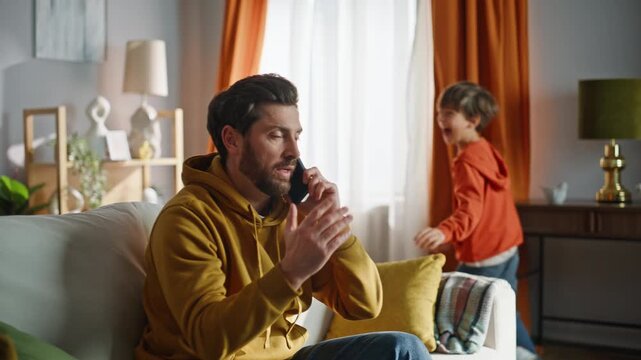 Annoyed father calling cellphone distracted noisy son running around closeup.