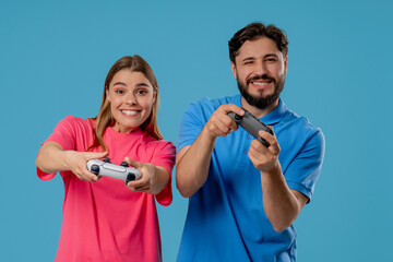 Gamers couple playing online video game on console TV with joysticks, wins. Presses buttons, using joypad controller, newest wireless gamepad. Hobby, e-sport. © kohanova1991