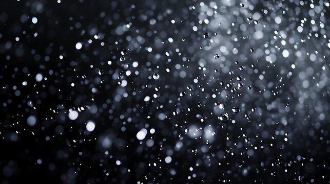 Abstract background featuring a high contrast display of falling water droplets against dark space