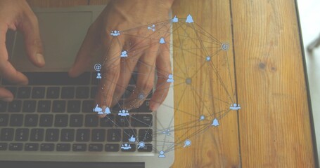 Typing hands with bare arms on laptop keyboard, trackpad on wooden table at home, social overlay