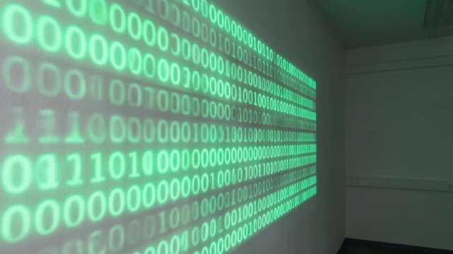 regulatory framework concept. Binary code projected on a wall inside an office or room with a ceiling vent.
