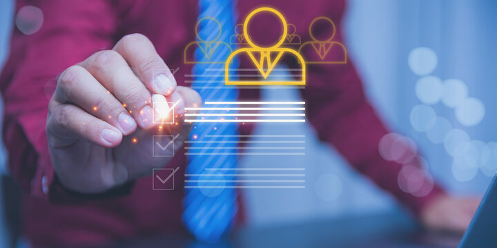 An HR professional interacts with a glowing digital interface to check off requirements on a candidate is profile.