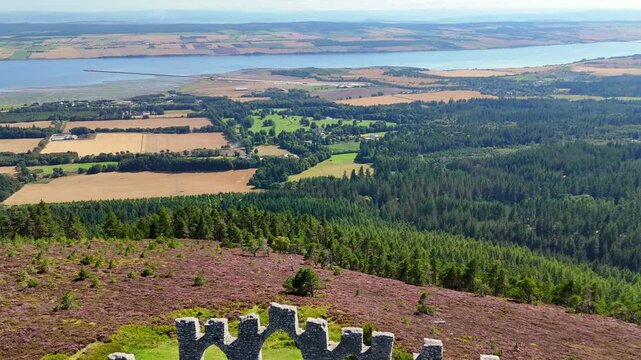 Drone Footage of Fyrish Monument Landmark, Scottish Highland Scenery, Purple Moorland, and Historic Stone Structures.