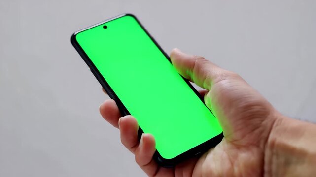 Modern smartphone close-up with green screen studio setup cinematic shot minimal background natural lighting for digital content