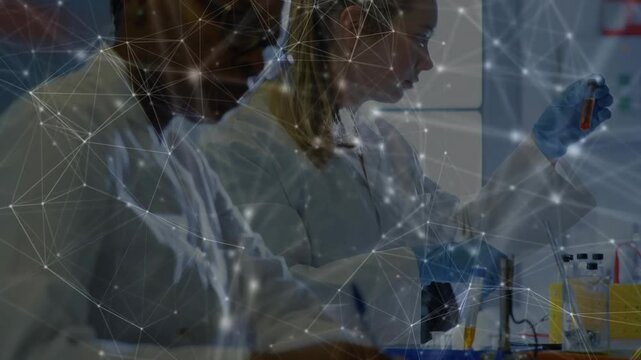 Pipetting lab techs inspecting test tubes at bench, wearing white coats, blue gloves, mesh overlay
