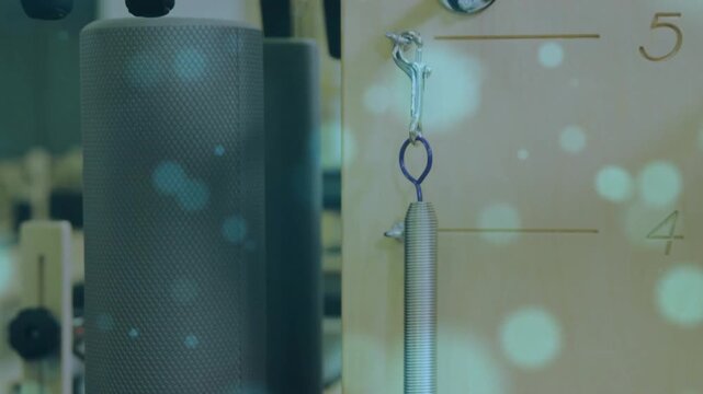 Camera shifting right, coil spring with blue ring aligning to panel pegs, demonstrating mounting