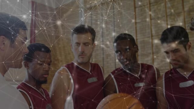 Huddling male players and coach listening, raising ball at gym, orange basketball maroon jerseys