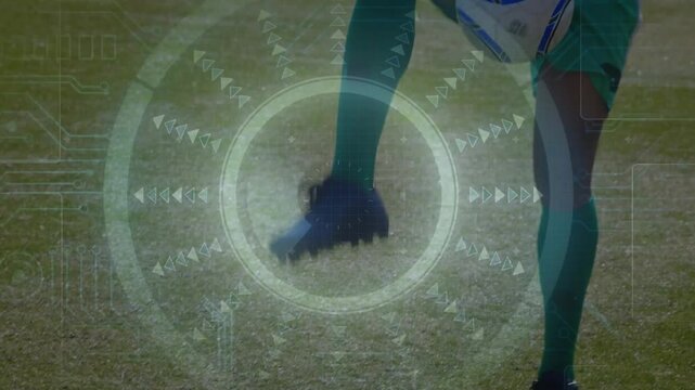 Performing male soccer player controlling white-blue ball on grass field, wearing teal kit, HUD