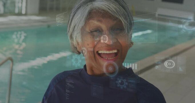 Vertical video: Laughing senior woman navy swim top reacting to digital UI appearing at pool ladder