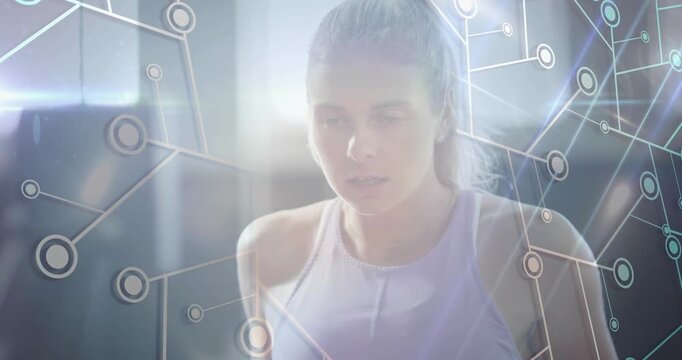 Female exerciser leaning forward, breathing, starting pulling reps in gym, overlay syncing tracker