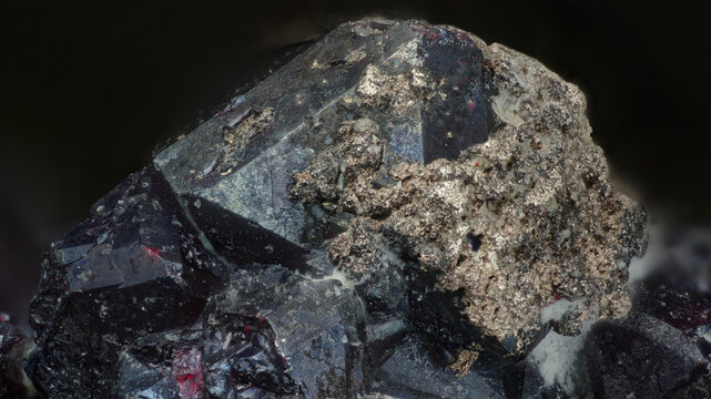 Macro image of native silver metallic formations on cuprite dark red octahedral crystals from Altai, Russia, via microscope, 9x magnification, 4mm field of view