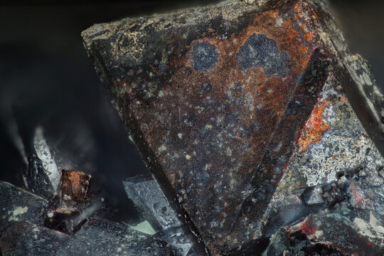 Macro view of cuprite dark red cubic crystals with metallic luster, Altai, Russia. Secondary copper oxide mineral from oxidation zone. Microscope 9&times;, 4mm FOV, for geology education