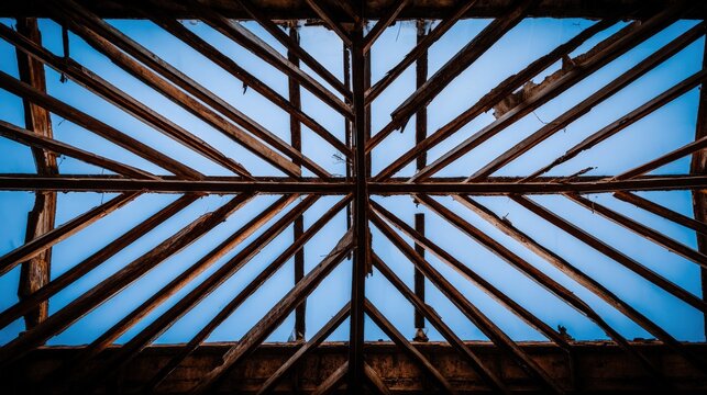 Symmetrical Radial Wooden Roof Trusses Create Starburst Frame Against Sky