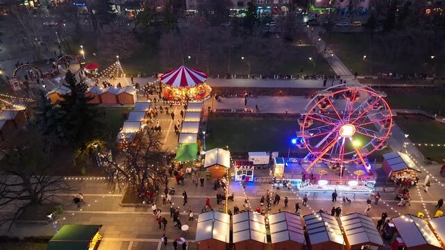 Aerial view fun fair. Twilight time illumination Sofia city famous theme amusement park downtown aerial panorama. 4k. Bulgaria from above