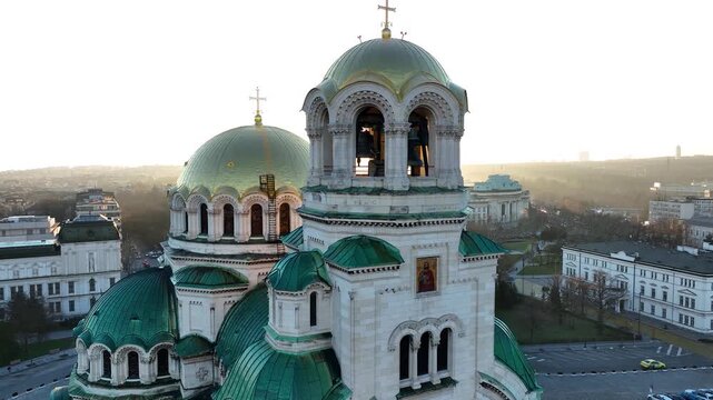 Аerial view of the capital of Bulgaria - Sofia. Iconic building. Close-up and backlight view of the St. Alexander Nevsky Cathedral at sunrise or sunset. The largest church in the Balkans. Movement.