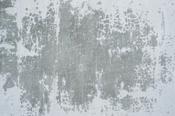 Close up of peeling white paint on weathered concrete surface with soft crack, abstract grunge texture background