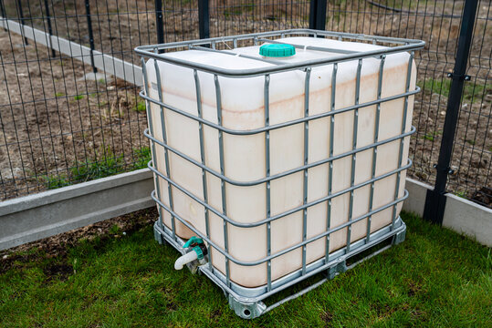 Ibc tote container collecting rainwater in garden