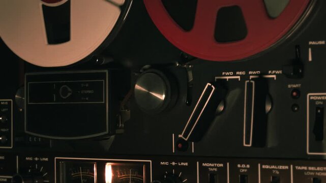 Vintage reel to reel tape deck playing. Close-up video loop, of an old analog reel-to-reel tape recorder in operation. Retro recording music concept b-roll footage