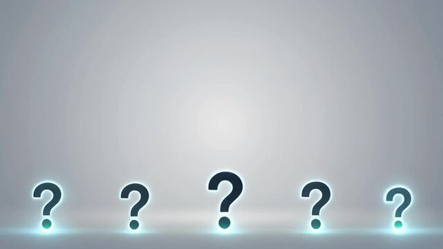 Glowing question marks on a gray background with a spotlight shining behind them, possibly used for educational or presentation purposes